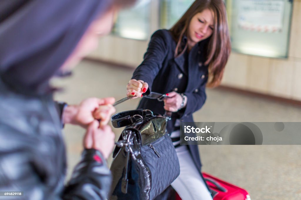 Street thief tryig to steal young womans bag...woman is fighting for her property Bag Stock Photo