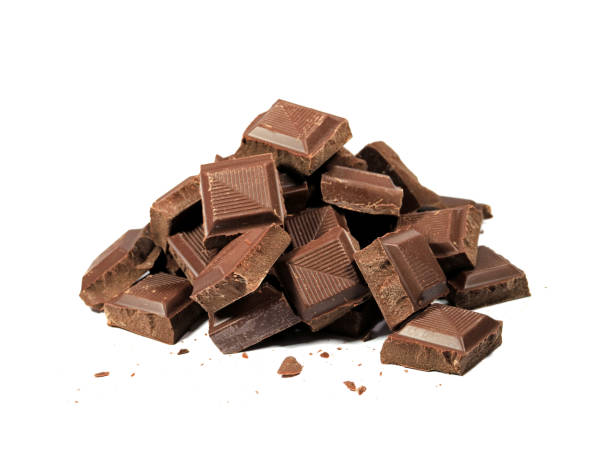 istock Pile of chocolate chunks isolated on white background 694829394
