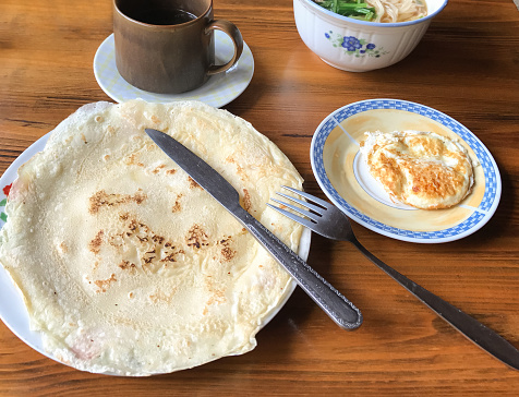 travel to China - pancake and omelette in chinese cafe in in Chengyang village of Sanjiang Dong Autonomous County