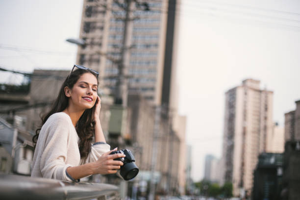istock Cute woman photographer 694832324
