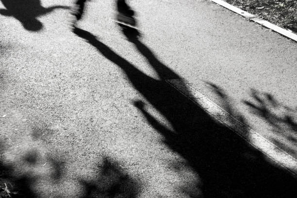 istock Blurry skaters silhouettes and shadows 694836134