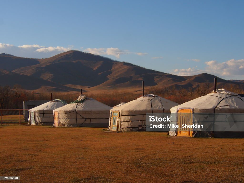 Traditional Mongolian Gers The warm sunset lights up the traditional Mongolian gers in the steppe outside Ulaanbaatar Independent Mongolia Stock Photo