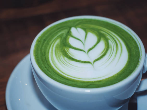 istock art latte hot green tea matcha on wooden table. 694842410
