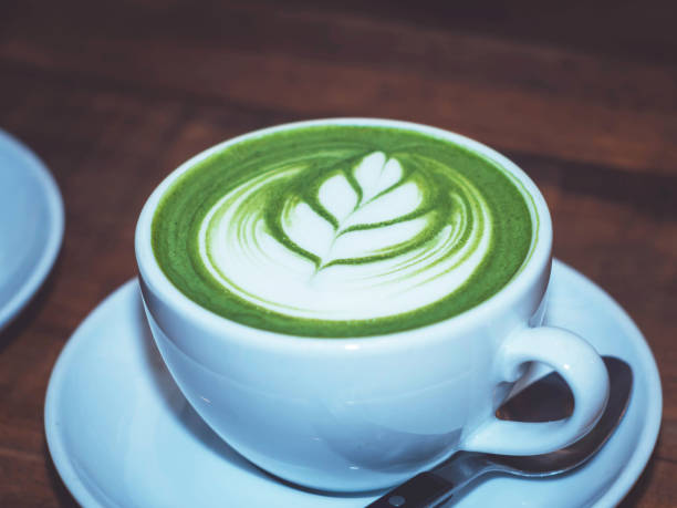 istock art latte hot green tea matcha on wooden table. 694844888