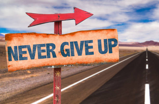 never give up - success failure dreams road sign imagens e fotografias de stock