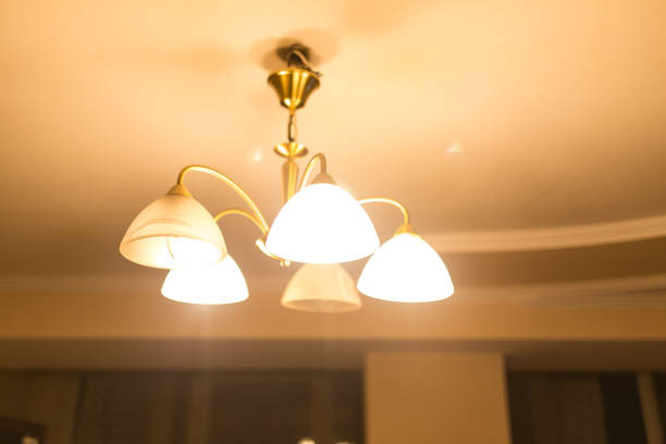 istock Burning lamps in a chandelier 694847992
