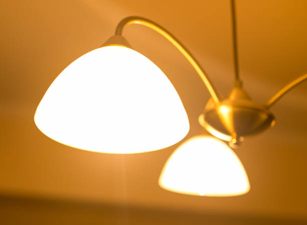 istock Burning lamps in a chandelier 694848820