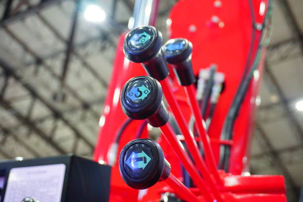 istock Hydraulic tubes, fittings and levers on control panel of mechani 694849270