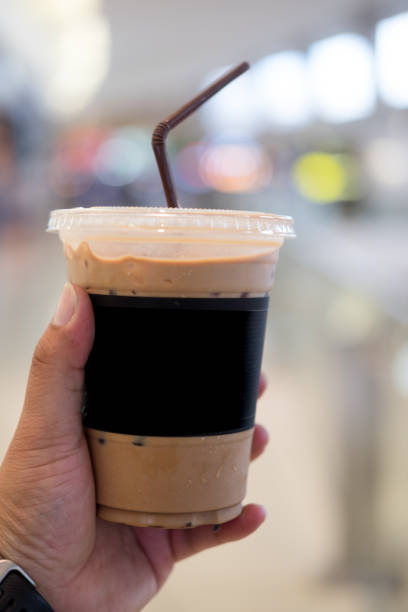 istock Ice mocha coffee in young man hand 694852582