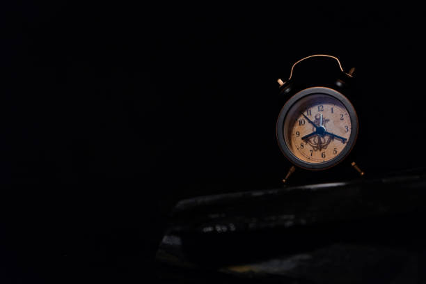 istock An alarm clock on the black bcakground 694855492