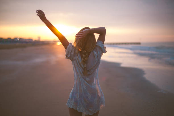 istock Dreamy girl  on beach 694858582