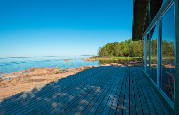 istock Sunny summer reflections on seaside terrace windows 694868990