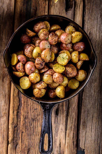 istock Pan Fried Yukon Gold Potatoes with Herb in Cast iron 694869910