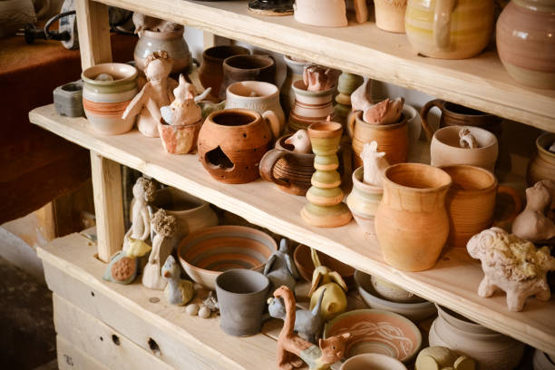 istock many different pottery standing on the shelves in a pottery workshop. Low light 694872528