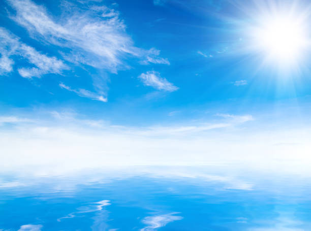 istock white fluffy clouds with rainbow in the blue sky 694878928