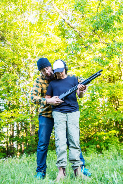istock Boy being taught how to shoot a rifle safely 694891348
