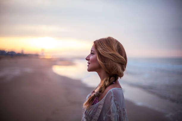 istock Dreamy girl  on beach 694894102