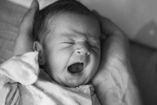 istock Newborn baby yawning 694894120