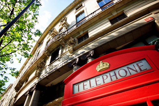 The entrance to the London School of Economics with an old red GPO telephone box in the forground. This was taken in London, UK with a wide angle lens.