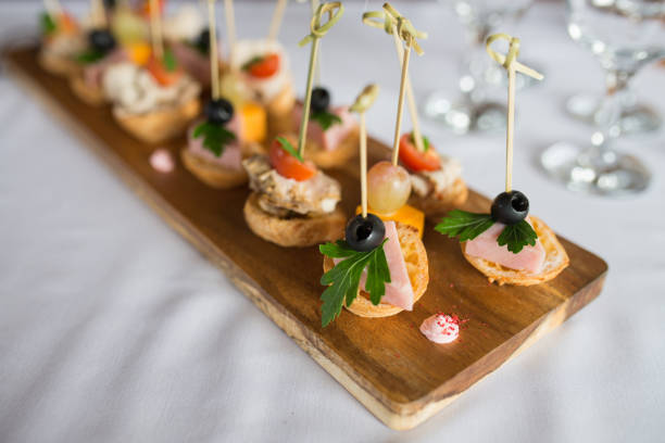 istock cold meat plate and bread sticks, small snacks canape with cherry tomatoes, cheese, sausages, vegetables on skewers 694903370