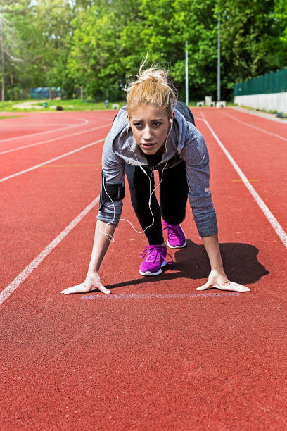 istock Young woman getting ready to run 694903538