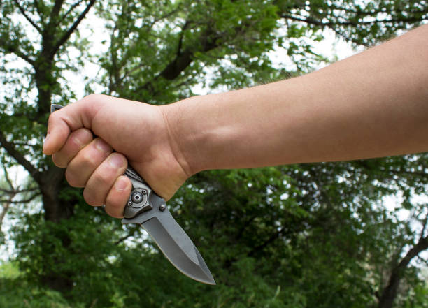 istock The hand of a man with a knife 694903638