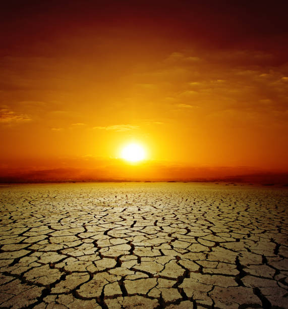 istock red sunset over drought earth. change of climate 694909740