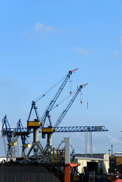 The port of Hamburg with a crane The port of Hamburg with a crane in the background and blue sky övelgönne stock pictures, royalty-free photos & images