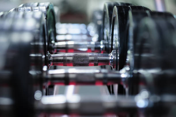 istock Row of spinlock dumbbels in special rack 694910382