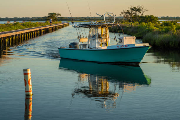 Intracoastal morning Emerald Isle, NC - May 27, 2017: A small fisherman boat is coming back from early morning trip. emerald isle north carolina stock pictures, royalty-free photos & images