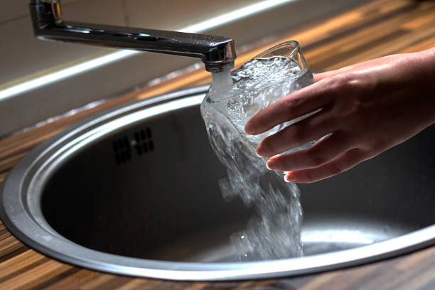 istock Filling glass of water in hand 694915886
