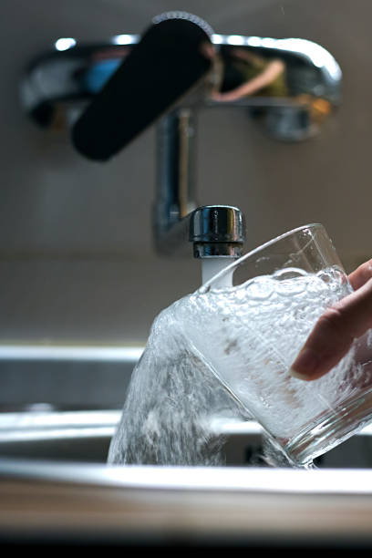 istock Filling glass of water in hand 694916080