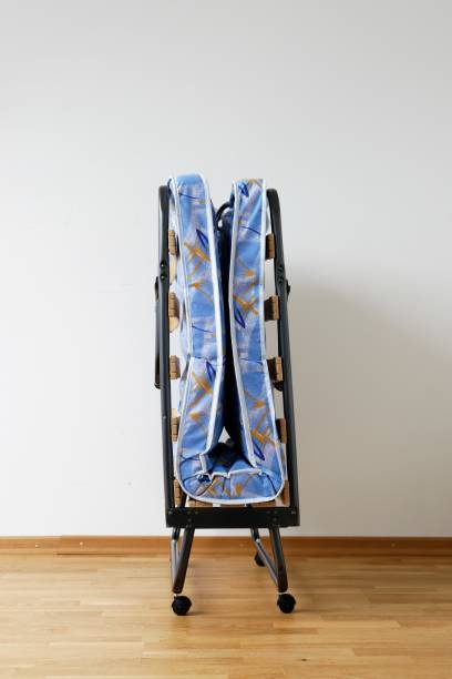 istock A folding bed in front of a white wall 694918422