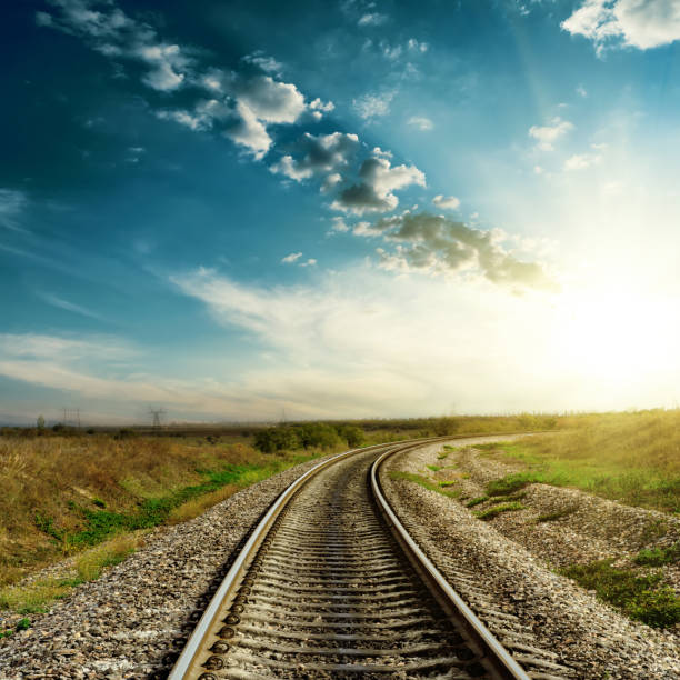 istock sunset in blue sky over railroad 694918552