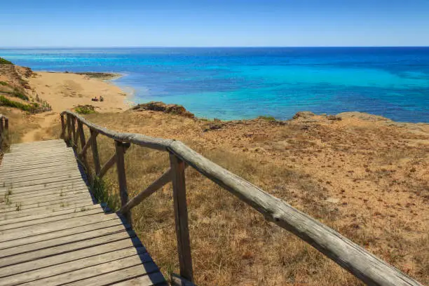 The most beautiful beaches of Italy. Campomarino dune park: fence between sea dunes,Taranto (Apulia). The protected area extends along the entire coast of the town of Maruggio.