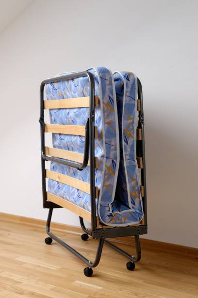 istock A folding bed in front of a white wall 694918786