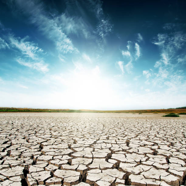 istock drought earth and sunset in dark sky 694924624