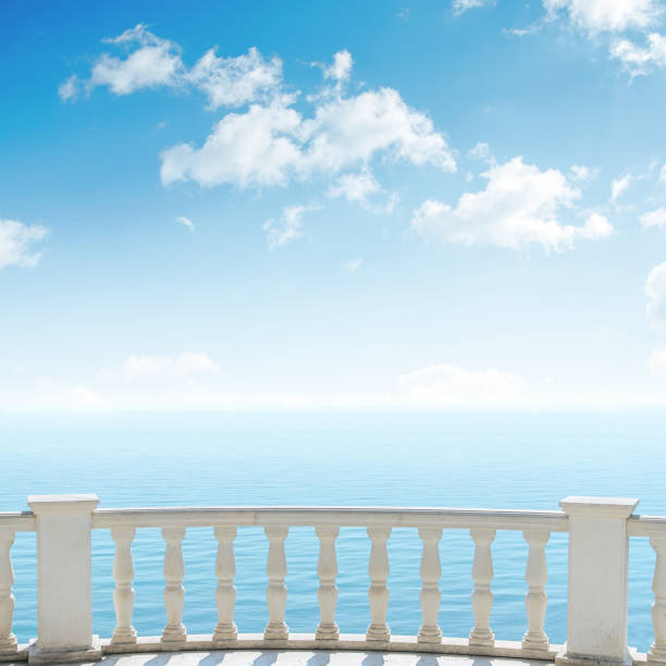 istock balcony over sea and clouds in blue sky 694924764