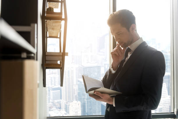 Contented pleasant man with stubble is resting in office