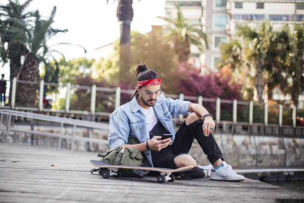 istock Skater guy in park sitting 694928030