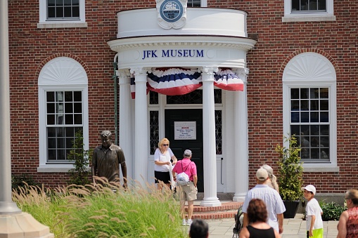 Hyannis, Massachusetts, USA - July 24, 2014: Tourists near the entrance to the JFK Museum located on Main Street in downtown Hyannis, Masachusetts.