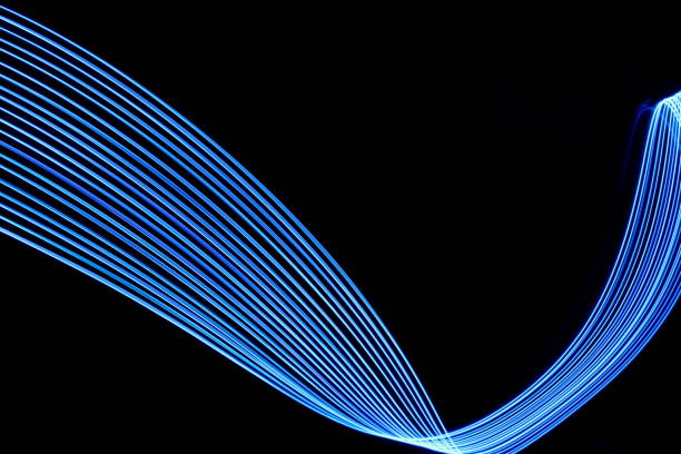istock Blue Light Painting Photography, parallel lines pattern on a black background 694928524