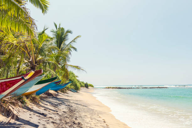 Canaries, St Lucia- November 2, 2019- Colorful old wooden fishing boats with interesting names are pulled up onto the sandy beach in the little fishing village of Canaries.
