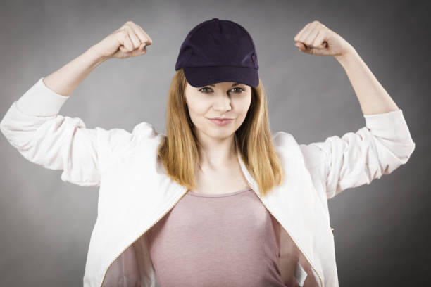 istock Young woman showing her arm muscles 694941136