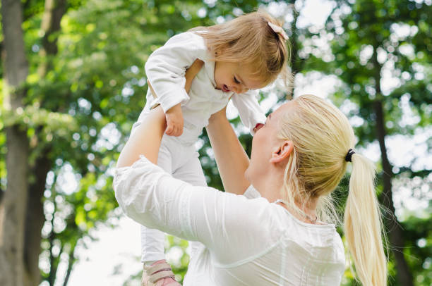 istock Mother throws baby in the air 694941292