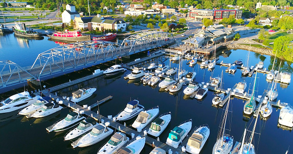 Sturgeon Bay Wisconsin Canal Waterfront with sailboats, bridge and tugboats, aerial view.