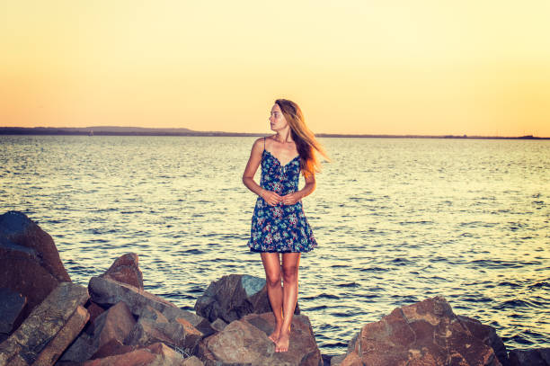 istock Young Woman Waiting for You on Sunset 694945028