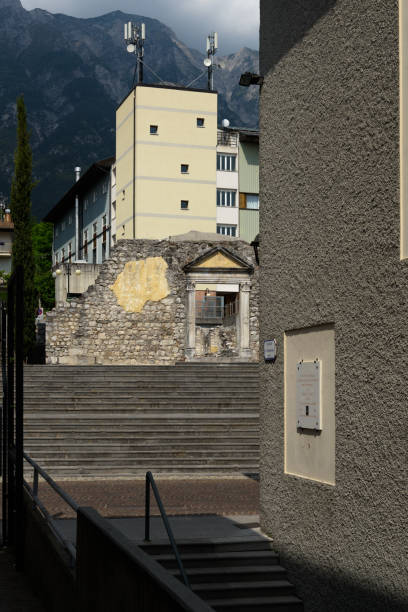 Gemona del Friuli, Church of the Blessed Virgin of Graces Gemona, Italy - June 02, 2017: Remains of the church of the Blessed Virgin of Graces in contrast to the new buildings, witnessing the devastation of the 1976 earthquake gemona del friuli stock pictures, royalty-free photos & images