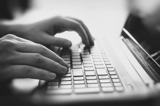 istock Male hands on a laptop keyboard 694960328