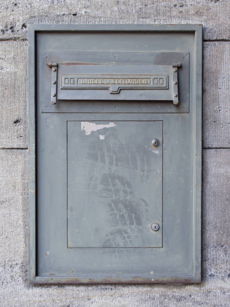istock Old Dirty Metal Mailbox With Writing Letters And Newspapers In German Language 694976836